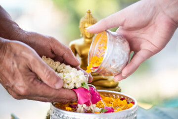  We express our respect to our elders by pouring flowers scented water onto our parents' and...