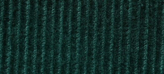 Texture of soft dark green knitted fabric as background, top view