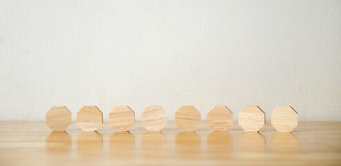 8 blank octagon wood blocks on table over white background, copy space for text