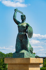 Statue of Syrenka, the Warsaw Mermaid, at Vistula River bank in Warsaw, Poland