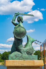 Fototapeta premium Statue of Syrenka, the Warsaw Mermaid, at Vistula River bank in Warsaw, Poland