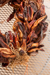 Detail of a wreath made of dried chili - 729717995