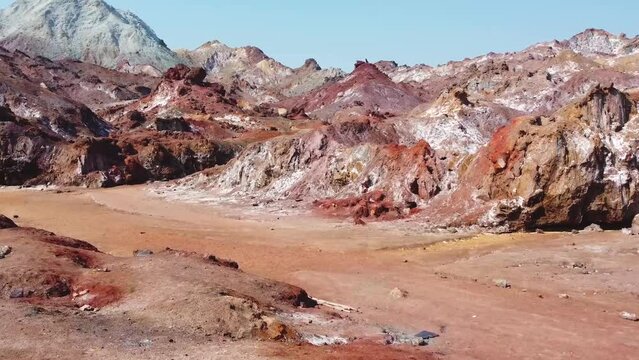 rainbow mountain landscape in aerial wide view fly moving shot spot colorful pillar stone in vivid nature coastal beach salt peak in background in Qatar Iran marine Hormuz Island wonderful attraction