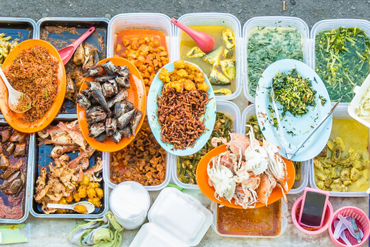 Variety of delicious Malaysian home cooked dishes sold at street market stall in Kota Kinabalu Sabah from top angle view.