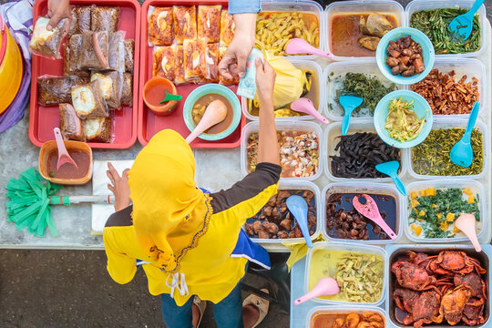 Variety of delicious Malaysian home cooked dishes sold at street market stall in Kota Kinabalu Sabah from top angle view.