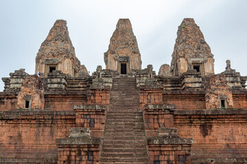 Red brick and stone temple ruin building pagoda structures complex Pre Rup Angkor Wat historical site park in the forest of Siem Reap Cambodia