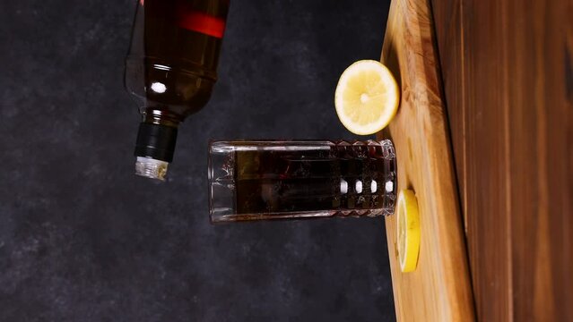 Piscola cocktail, Typical Chilean drink wooden table dark background Chile Pisco, Ice and Coke.