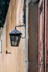 Beautiful old lantern on an ocher wall in the center of Florence