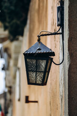 Beautiful old lantern on an ocher wall in the center of Florence