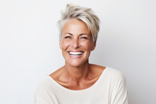 Portrait of a happy mature woman looking at camera over white background