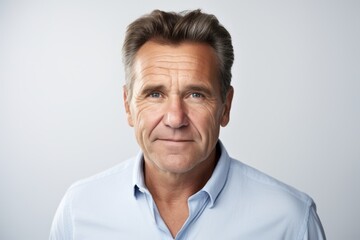 Confident mature man looking at camera. Isolated on grey background.