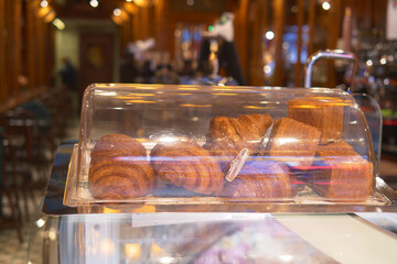 vertical sho or fresh baked croissant in a glass transparent container at shop 