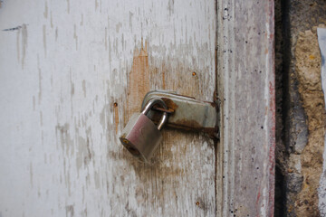 Old door with rusty padlock