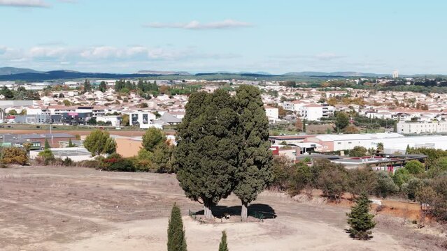 Nestled in charming town of Saint Aunes, two majestic cypress trees stand proudly