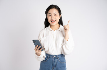 Portrait of young Asian businesswoman using phone on white background