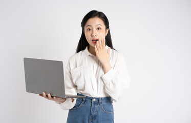 Portrait of young Asian businesswoman using laptop on white background