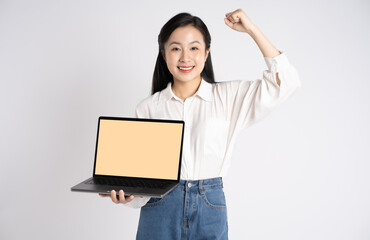 Portrait of young Asian businesswoman using laptop on white background