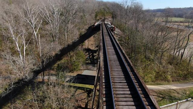Aerial Shot Pushing Forward Along the Tracks of the Pope Lick Railroad Trestle in Louisville Kentucky on a Sunny Winter Day.