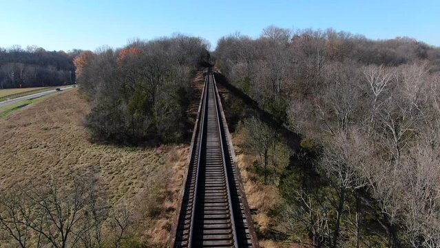 Aerial Shot Pushing Forwards Along the Pope Lick Trestle Railroad Tracks on a Sunny Afternoon in Louisville Kentucky.