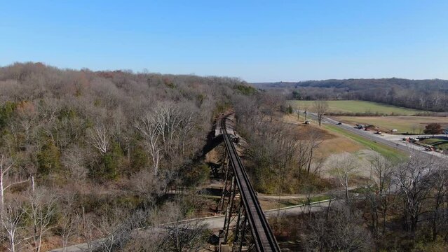 Aerial Shot Pushing Towards the End of the Pope Lick Railroad Trestle in Louisville Kentucky on a Sunny Afternoon.