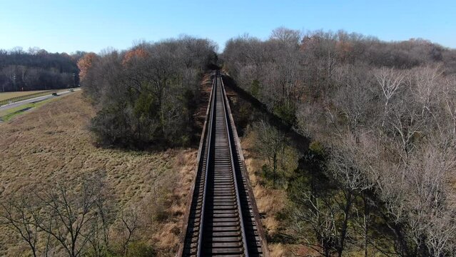 Aerial Shot Pushing Forwards Along the Pope Lick Trestle Railroad Tracks on a Sunny Afternoon in Louisville Kentucky