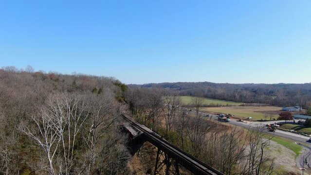 Aerial Shot of Railroad Tracks Winding Out of a Forest and on to the Pope Lick Trestle in Louisville Kentucky.