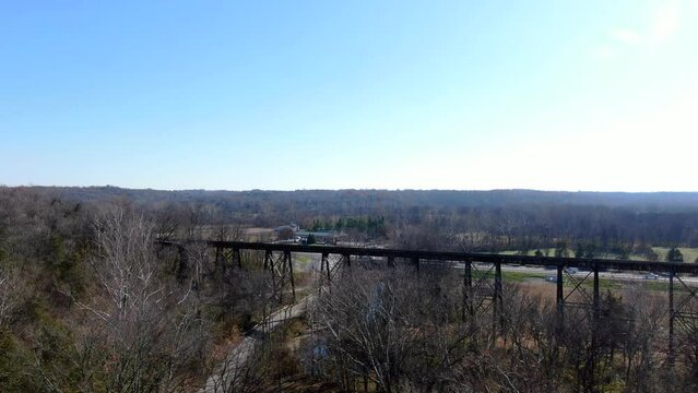 Aerial Shot Pushing Over a Forest Towards the Pope Lick Trestle in Louisville Kentucky on a Sunny Afternoon