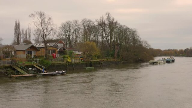High angle shot over Thames river from Twickenham area in London, England on during evening time.