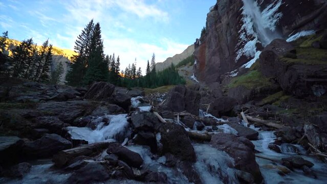Telluride Colorado sunset stream Bridal Veil Falls frozen ice Waterfall fall autumn sunset cool shaded Rocky Mountains Silverton Ouray Millon Dollar Highway historic town scenic landscape slow pan up