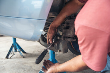 Close up Man hands fixing Car machinery vehicle mechanical service. Mechanic man hands repairing car auto repair shop. open vehicle hood checking up auto mobile. Vehicle Car maintenance engineer.