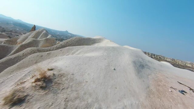 Hilly Sand Dunes In Turkish Village In Cappadocia, Turkey. FPV drone shot