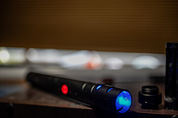 Assorted parts to build a laser sword from a kit with a hilt, neon blade, sound board and control chip. 