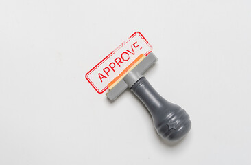 Rubber stamp with red approve wording on white paper for document approval such as financial loan , quality ISO and project acceptance concept.