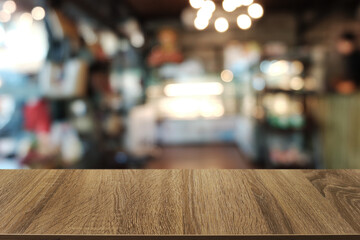 Empty dark wooden table in front of abstract blurred boken bankground of restaurant. Can used for display or montage your products. Mock up for space.