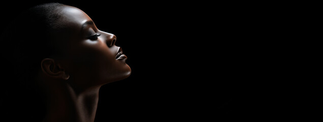 Close up of a model black woman face profile on a black background