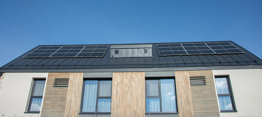 Fototapeta premium solar panels on rooftop modern village