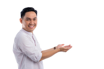 Happy Asian Muslim man showing copy space on palm isolated on white background. Ramadan and Eid Fitr celebration concept