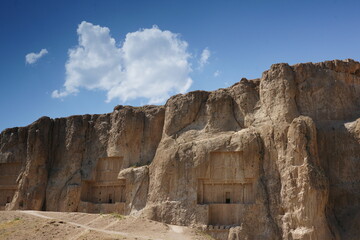 Naqsh-e Rostam is an ancient necropolis located about 12 km northwest of Persepolis, in Fars Province, Iran, with a group of ancient Iranian rock reliefs cut into the cliff.