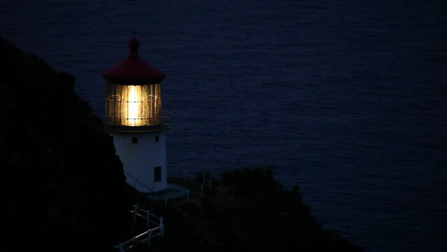 Smooth pan over dark ocean to old lighthouse