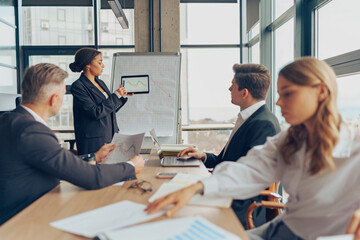 Obraz premium Team of business investors is discussing a new project in modern office. Concept of financing
