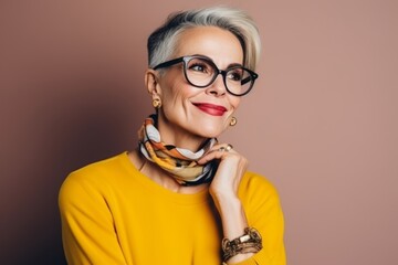 Portrait of a beautiful senior woman with short gray hair wearing glasses.