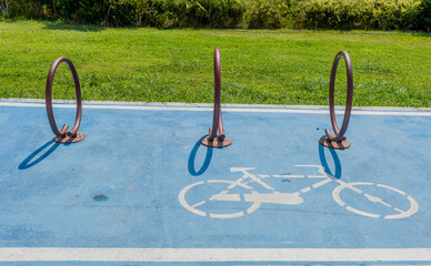 Urban bicycle parking with bike racks and painted cycling symbol