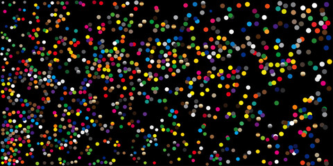 Colorful confetti scattered across a black backdrop, illuminated by a spotlight.