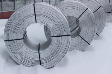 A coil of aluminum wire, in the snow