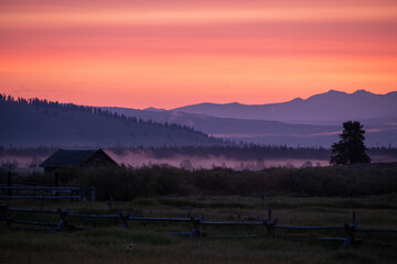 A misty sunrise dawning over the mountains in West Yellowstone