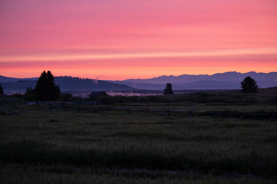 A misty sunrise dawning over the mountains in West Yellowstone