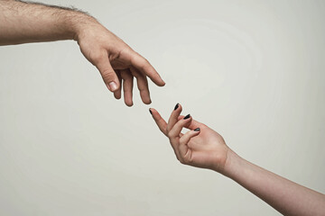 Touch of two hands. Man and woman hand about to touch with index finger. Couple hands reaching to...