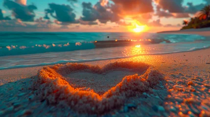 Fotobehang Heart shape on the beach at sunset time. Concept of love and romance © Aliaksandra