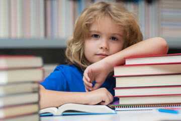 Child reading book in library on bookshelf background.