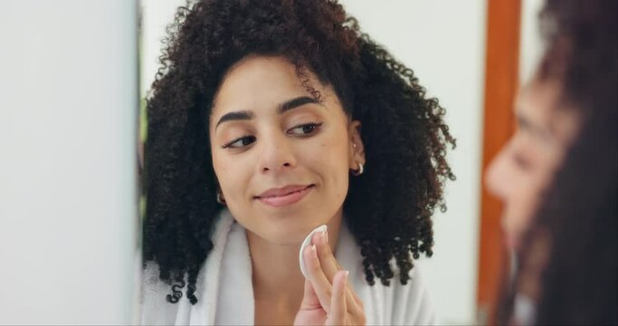 Home, cotton pad and woman with skincare, mirror and beauty with grooming and morning routine. Person, apartment and girl in a bathroom and reflection with makeup removal and clean with dermatology